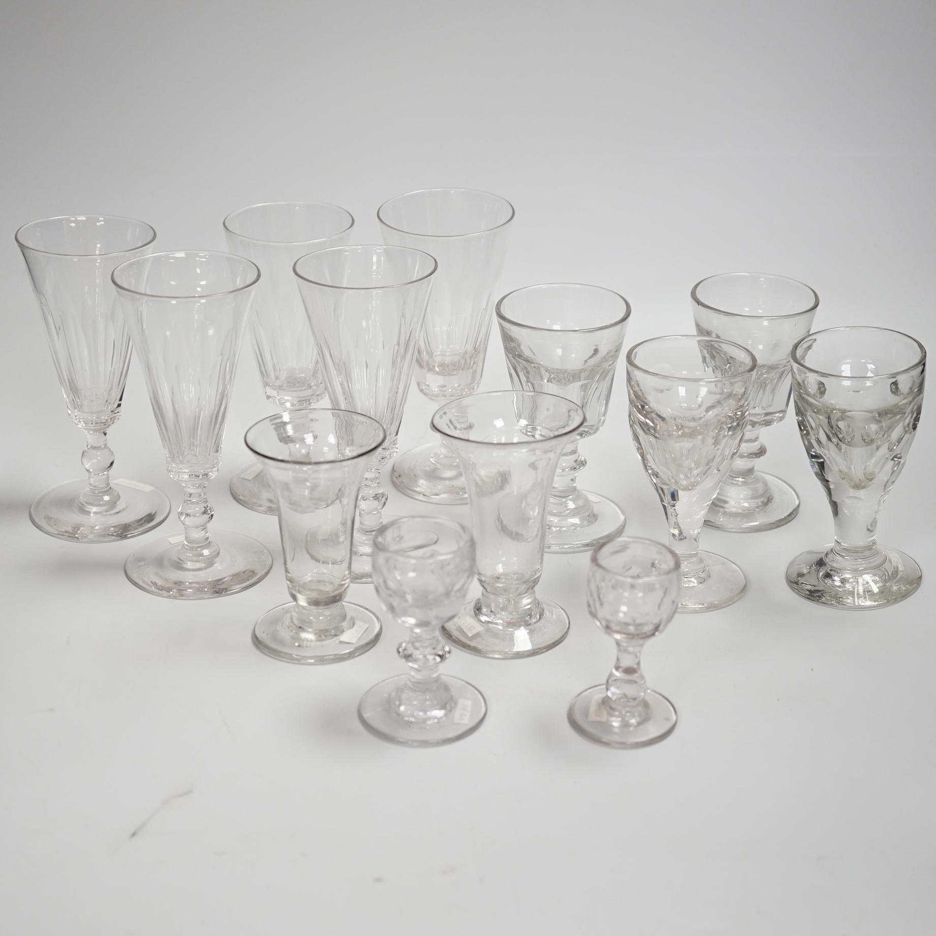 1429, 1430, 1451, 1439 & 1435 A harlequin set of five English lead crystal short ales, c.1820-30, decorated with cut rounded facets, two with blade and three with ball knops, height 14.2cm, together with three pairs of 1